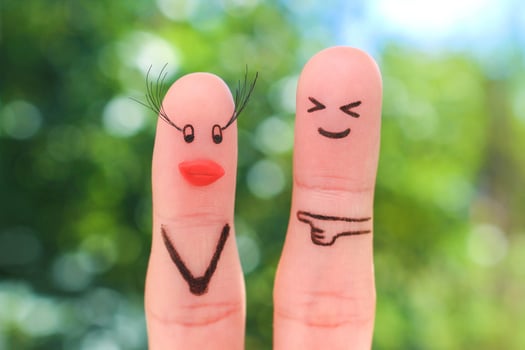 Fingers art of couple. Man does not like how woman has increased eyelashes, silicone lips. photo