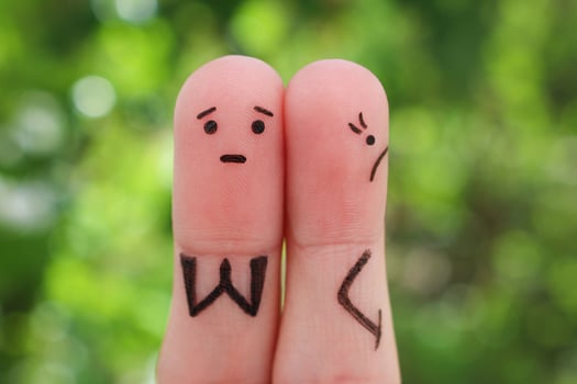 Fingers art of displeased couple. Woman was offended, man asks her forgiveness. photo