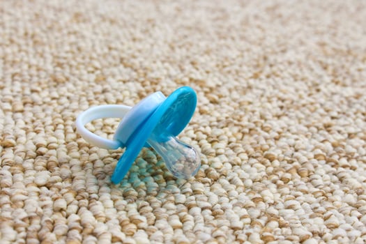 Baby pacifier fell on the dirty floor. photo