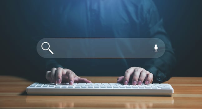 Businessman hand typing on a keyboard with bar tool to search for information Using for your website, the discovery of information, search engine optimization photo