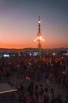 People walking towards sunset at a festival in the desert at the Burning Man Festival. photo