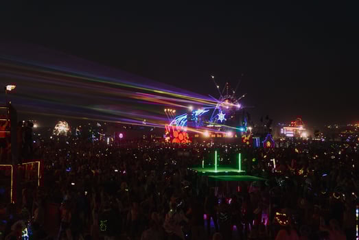 People walking towards sunset at a festival in the desert at the Burning Man Festival. photo
