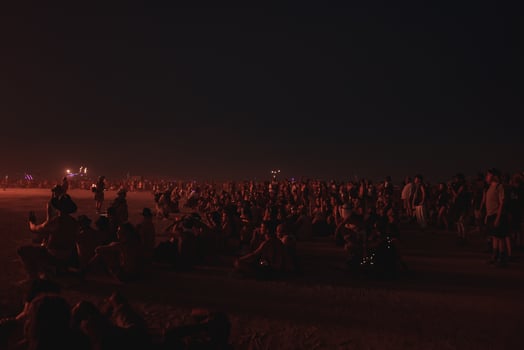 People walking towards sunset at a festival in the desert at the Burning Man Festival. photo