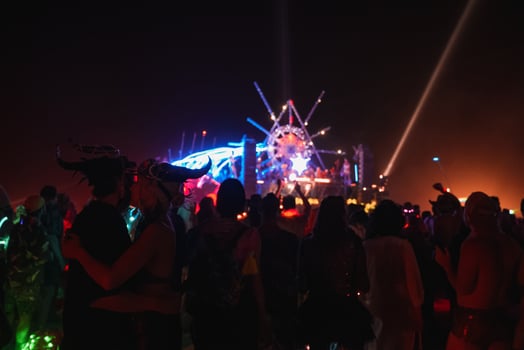 People walking towards sunset at a festival in the desert at the Burning Man Festival. photo