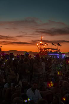 People walking towards sunset at a festival in the desert at the Burning Man Festival. photo