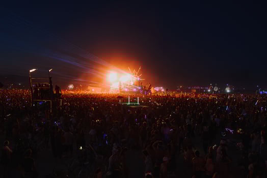 People walking towards sunset at a festival in the desert at the Burning Man Festival. photo