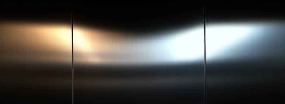 Stainless steel large sheet  With light hitting the surface,Inside passenger elevator,Reflection of light on a shiny metal texture,stainless steel background,metal texture background. photo