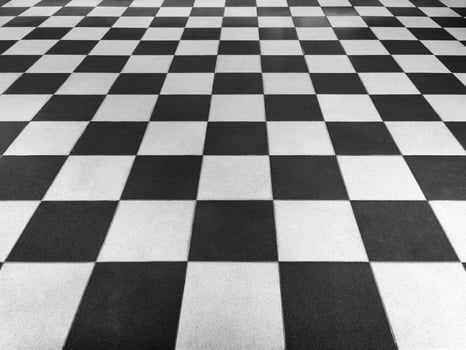 Black and white tiled floor symmetrical with a grid texture in front view for a permanent tiled floor background. black and white square Made of ceramic material for flooring photo