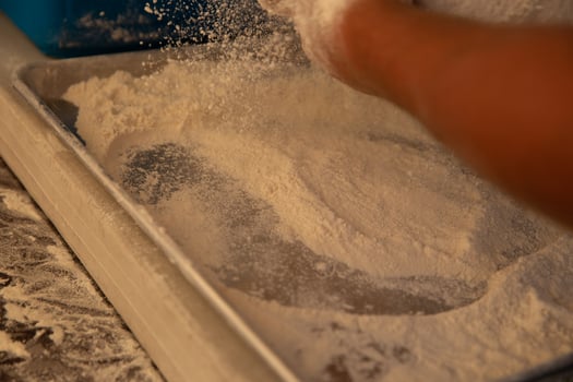 Chef Sprinkling flour and spreading it photo