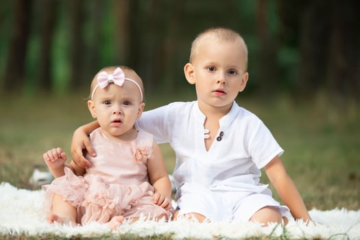 Portrait of an older brother and little sister for a walk in the park. photo