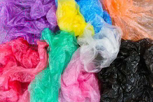 Different plastic bags on old wooden background. Top view. photo