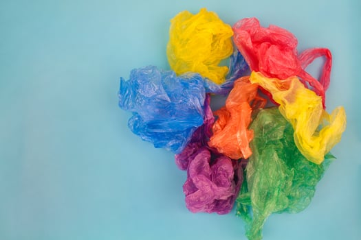 Different plastic bags on blue background. Top view. photo