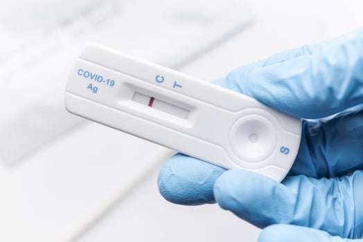 Doctor holding a negative result for COVID-19 with test kit for viral disease. photo