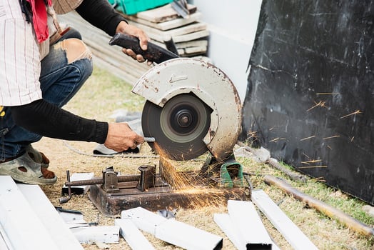 construction man working with steel cutting and grinding machine, people working at construction site concept photo