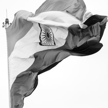 India flag flying high at Connaught Place with pride in blue sky, India flag fluttering, Indian Flag on Independence Day and Republic Day of India, tilt up shot, Waving Indian flag, Har Ghar Tiranga photo