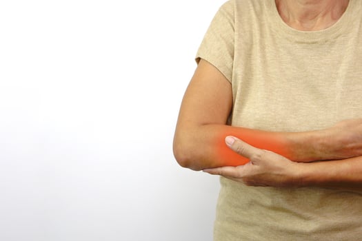 Woman suffering from elbow pain on white background. Healthcare and office syndrome concept. photo