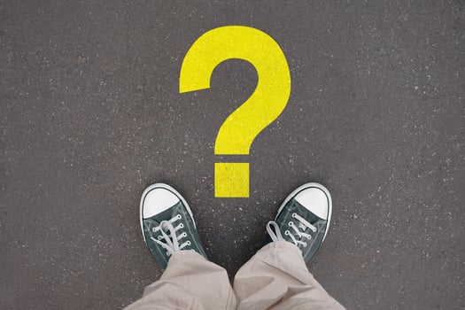 Question mark - legs with trainer shoes photo