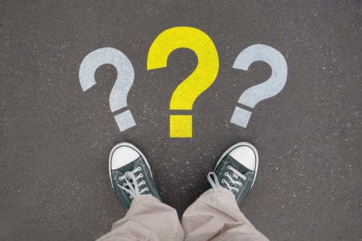 Question marks - legs with trainer shoes photo