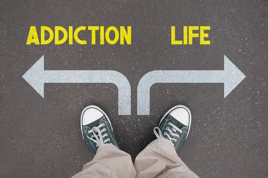 Addiction and life concept - legs with trainer shoes photo