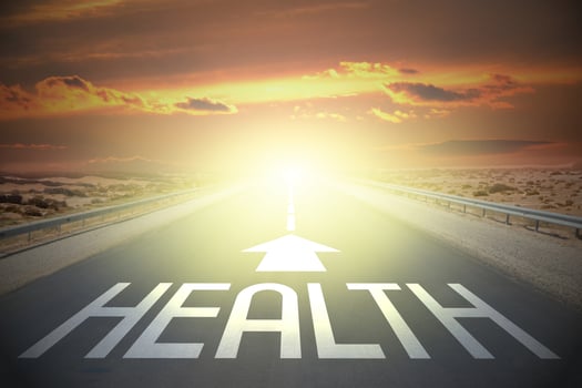 Health word on a road and sunset sky photo