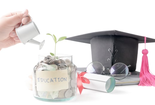 ittle hand watering a tree growing out of silver coins photo