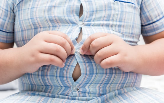 Obese fat boy overweight. Tight shirt of pajamas photo