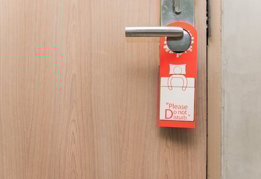 Do not disturb sign on door knob photo