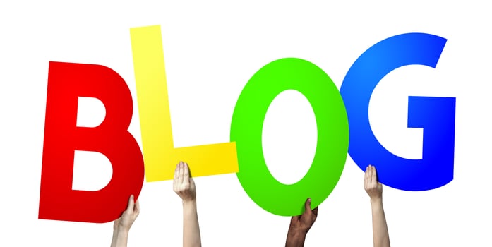 Blog - Human Hands Holding Colorful Letters photo