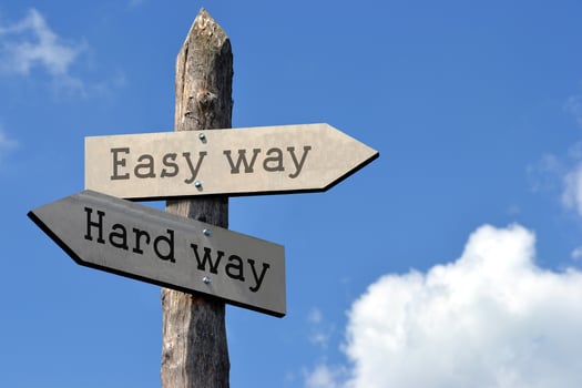 Easy or Hard Way - Wooden Signpost with Two Arrows, Sky with Clouds photo