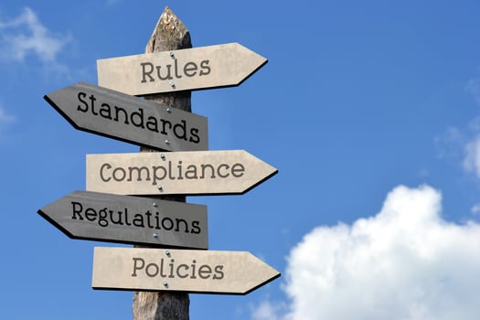 Rules, Standards, Compliance, Regulations, Policies - Wooden Signpost with Five Arrows, Sky with Clouds photo