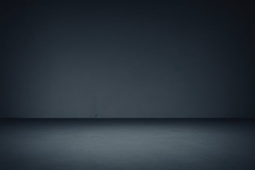 spotlight in dark room, smoke on the floor background, blue backdrop photo