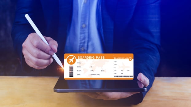 Hand holding boarding pass tickets air travel concept, Choosing checking electronic flight ticket on laptop. photo