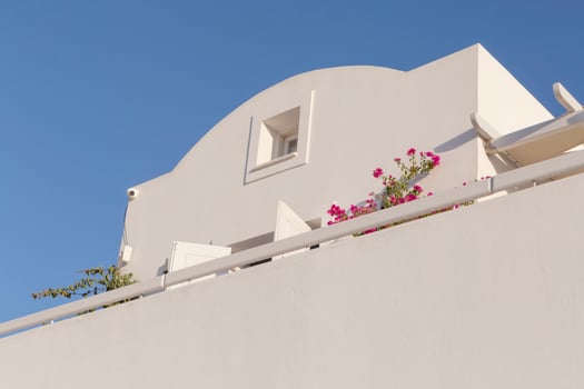 traditional white building on Santorini against blue sky photo