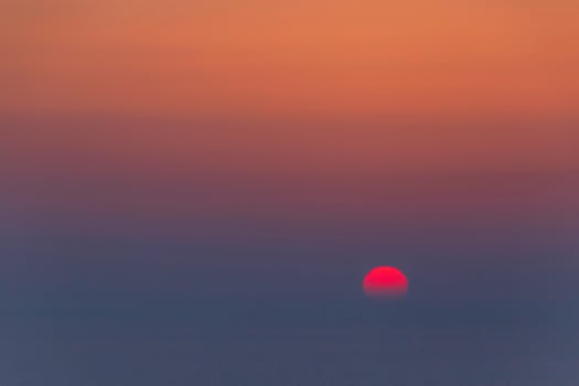 sun going down behind the sea photo