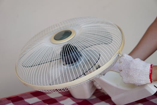 Closeup mechanic hands combine part of electric fan. Concept, maintenace appliance, electric devices in daily life, check ,repair or fix when it has problems for long using. photo