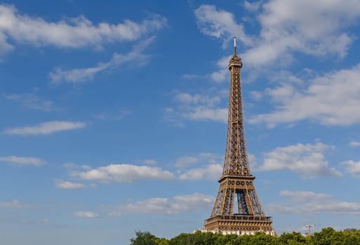 Eiffel tower against blue sky with clouds photo