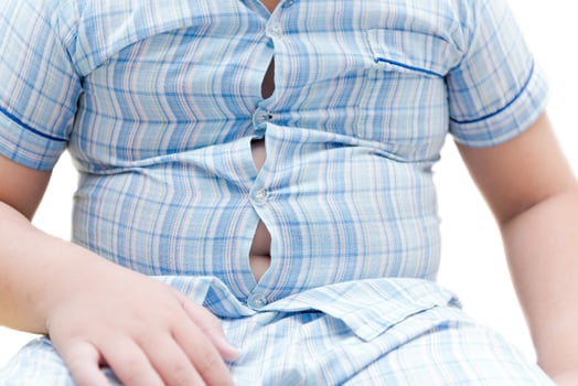 Obese fat boy overweight. Tight shirt of pajamas photo
