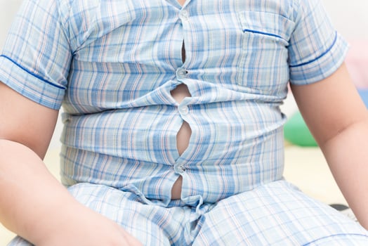 Obese boy overweight. Tight shirt of pajamas photo