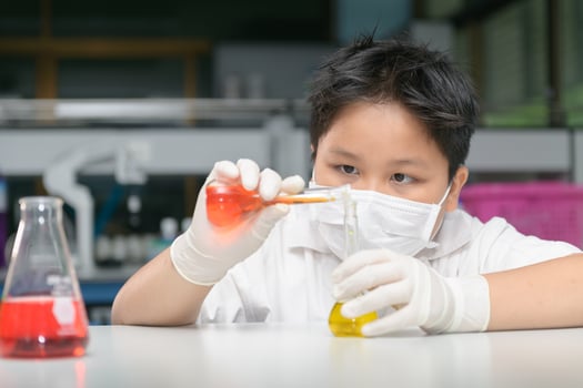 kid scientist making experiment with test tube i photo