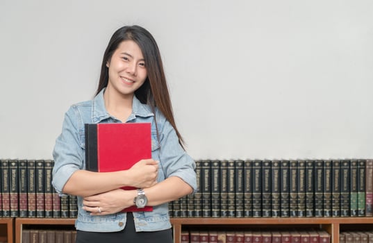 Confident smiling student asian girl in the library university photo