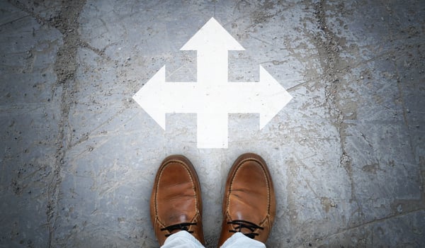 Brown Leather Shoes and Chalky Arrows in Three Directions on Asphalt - Choice Concept photo