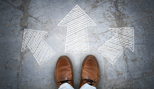 Brown Leather Shoes and Three Geometrical Chalky Arrows on Asphalt - Choice Concept photo