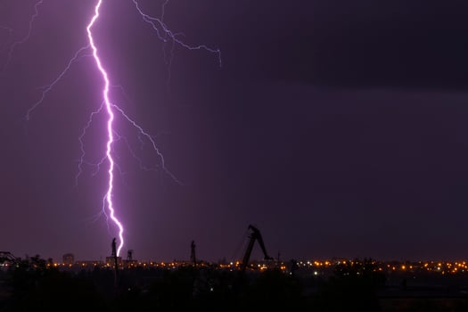 landscape with lightning striking a building photo