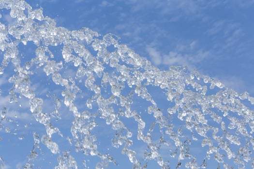 fountain jets against blue sky photo