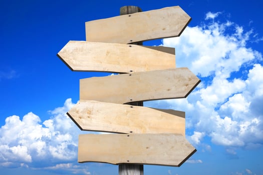 Wooden Signpost with Five Clear Arrows, Sky with Clouds in Background photo