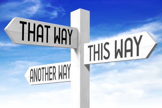 This Way - Wooden Signpost with Three Arrows and Sky in Background photo