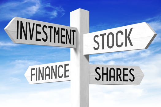 Finance Concept - Wooden Signpost with Four Arrows and Sky in Background photo