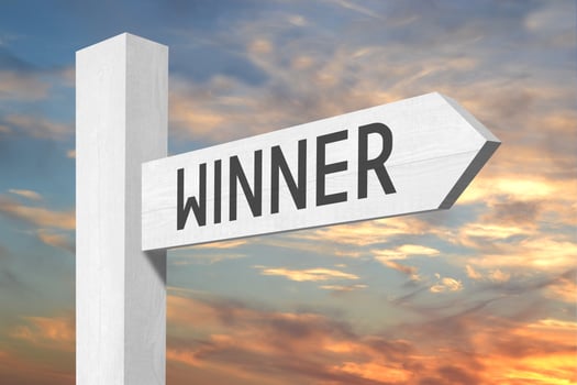 Winner - White Wooden Signpost with one Arrow and Sunset Sky in Background photo