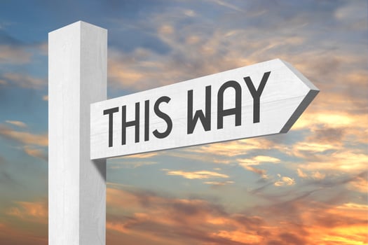 This Way - White Wooden Signpost with one Arrow and Sunset Sky in Background photo