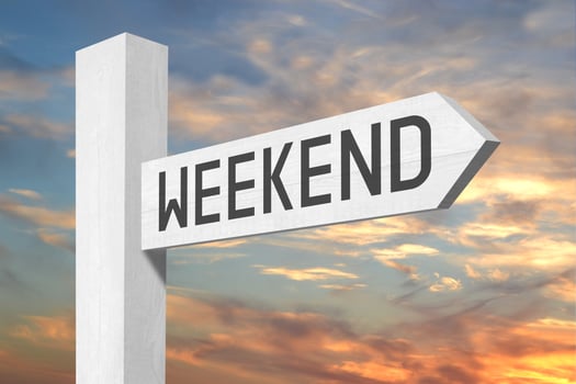 Weekend - White Wooden Signpost with one Arrow and Sunset Sky in Background photo